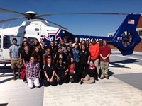 Students and teachers in front of a helicopter