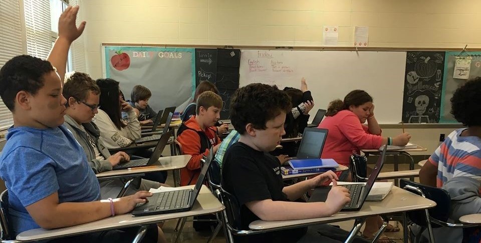 Middle School students in a classroom working on Chromebooks