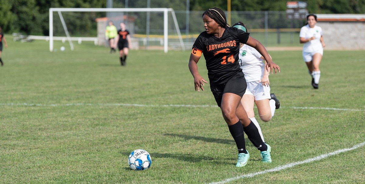 Girls Soccer player dribbling ball